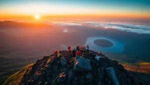 Hikers at sunrise on Mount Rinjani's crater rim with lush landscape and crater lake in the background.